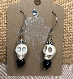 "Make all of your \"Ghoul-friends\" jealous with these adorable Skull Dangle Earrings. This is Spooky Vintage Glamour at its best!                                  The perfect October Hostess Gift  These bone- colored howlight skull beads are accentuated with black faceted crystals and 4mm Czech glass crystals.   1 1/4\"L x 1/2\" W These dangle skull earrings will complete your Halloween wardrobe! You want to see these earrings in multi- colors?! Check out the Colored Skull Earrings here: https: Skull Shaped Jewelry For Day Of The Dead Party, Skull Jewelry For Day Of The Dead Party, Handmade Bone Jewelry For Halloween, Gothic Skull Earrings For Halloween, Quirky Handmade Halloween Jewelry, Halloween Skull Jewelry With Ear Wire, Halloween Skull Jewelry In Bone Color, Halloween Skull Shaped Bone Jewelry, Spooky Skull Jewelry For Gifts