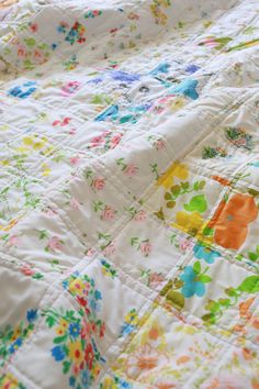 an unmade quilt with colorful flowers on it