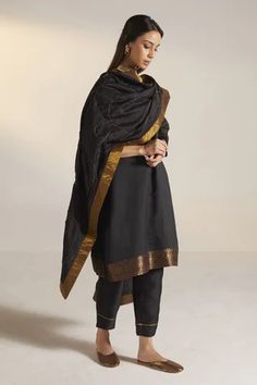 Black cutdana embellished dupatta featuring thick golden velvet border. Component: 1 Pattern: Hand Embroidery  Type Of Work: Leaves  Fabric: Handloom Silk Color: Black Other Details:  Embroidered Vines Approximate Product Weight: 500 grm Note:  Kurta, pants and choker shown in the image are not for sale. Since all our products are sustainable and touched by human hands for weaving, block printing and embroidery; there might be a slight imperfections that make them unique and individual. Occasion Ceremonial Black Handloom Dupatta, Black Tussar Silk Dupatta With Woven Motifs, Black Embroidered Chanderi Dupatta, Black Embroidered Border Unstitched Dupatta, Black Bohemian Embroidered Dupatta, Embroidery Leaf, Printed Sleeves, Fashion App, Three Quarter