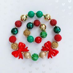 "Christmas Stretchy Big Bead Necklace and Bracelet for baby girl, toddler girl and little girl.  Necklace and bracelet are made with chunky red, gold, and green acrylic beads. Necklaces can be purchased in the 16\" or 18\" options. 16\" is recommended for baby girls and toddler girls. 18\" is recommended for girls 5 years of age or older. Necklace and bracelet can be purchased as stand alone items or as a set. Both necklace and bracelet are no clasp and elastic, easy to put on and take off.  For Holiday Gold Beaded Jewelry, Festive Adjustable 8mm Beaded Jewelry, Gold Round Beads Jewelry For Christmas, Holiday Adjustable Beaded Jewelry, Playful Red Stretch Bracelet For Gift, Colorful Beaded Round Jewelry For Birthday, Playful Red Jewelry For Birthday, Cute Adjustable Gold Beaded Necklace, Cute Christmas Festive Jewelry