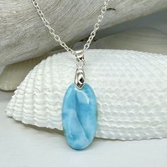 This beautiful high quality Larimar cabochon is a sky blue with no imperfections, as Larimar often has. This piece is so reminiscent of being at the beach, with it's seaside-like colors and white "waves"!  This lovely pendant will come on a dainty .925 sterling silver chain and a sterling silver lobster clasp.  If you have any questions, please just ask and I will be happy to help you. I have also included a diagram in the photo section to assist with necklace chain sizing. To order: *In the drop-down menu, please choose the Pendant With Chain and your Necklace Chain length (keeping in mind that the pendant is 1.5" tall). *It's no surprise that Larimar is a water stone; it has that ebbing energy of light dancing across the water and it seems to be infused with a sense of cleansing calm.  I Larimar Gemstone Pendant Necklaces, Larimar Gemstone Pendant Necklace, Oval Blue Larimar Jewelry, Light Blue Oval Gemstone Necklaces, Handmade Larimar Round Necklace, Handmade Round Larimar Necklaces, Blue Larimar Pendant Necklace, Light Blue Sterling Silver Pendant Necklace, Handmade Light Blue Sterling Silver Necklaces