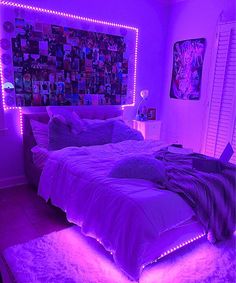 a bed with purple lights in a bedroom next to a window and pictures on the wall