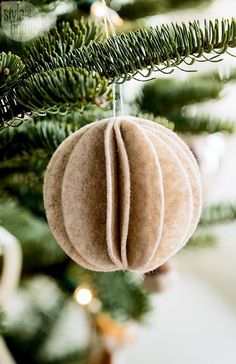 an ornament hanging from a christmas tree in the shape of a bauble