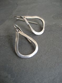 This item is made to order please allow 5 to 8 business days for your order to ship. A lovely alternative to the classic little hoop. These simple teardrop earrings were hand carved out of wax and then cast in 925 sterling silver. They are slightly oxidized and have a soft semi matte finish. To give them an organic feel, I have given them my signature uneven surface. The ear wires are also 0.925 sterling silver. These earrings measure a little less than 1 inch in length, without the lever back. Minimalist Sterling Silver Drop Earrings For Everyday, Everyday Minimalist Sterling Silver Drop Earrings, Everyday Minimalist Sterling Silver Drop, Hand Forged Silver Teardrop Earrings, Silver Oxidized Teardrop Earrings, Everyday Teardrop Earrings With Oxidized Finish, Minimalist Handmade Long Drop Teardrop Earrings, Everyday Oxidized Teardrop Earrings, Everyday Hand Forged Teardrop Earrings