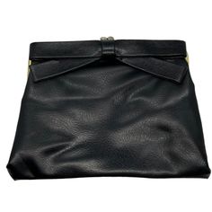 "Vintage 60's black leather clutch has a pretty bow on the front. Purse has a kiss closure with black satin interior. It measures 8\" by 6\". Clean condition inside and out. Please see photos for more details. All items are vintage that are preowned. All of the items may show some form of wear due to their age. Please kindly remember that these items are anywhere from 30-80 years old. I make every attempt to clearly describe the item, including any flaws or wear to the best of my ability. Return Black Formal Bag With Bow, Formal Black Bag With Bow, Black Clutch With Fold Over Clasp For Evening, Black Evening Clutch With Fold Over Clasp, Bow Clutch, Black Leather Clutch, Leather Bow, Leather Bows, A Kiss