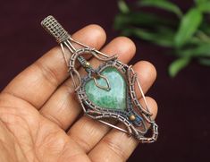 Unique Copper Flourite Heart Gemstone Copper Wire Wrap Pendant Jewelry/ Gift For Wife/ Oxidize Polish/ Flourite Heart Pendant Necklace Jewelry type : Item Type              : Pendant  Gemstone             : Labradorite  Material                  : Copper, Gemstone Pendant High        : 10.3 Centimeter Pendant Width      : 4.4 Centimeter Pendant Quantity : 1 Piece Handmade Green Heart-cut Jewelry, Handmade Green Heart Cut Jewelry, Handmade Green Jewelry For Valentine's Day, Natural Stones Heart Pendant For Jewelry Making, Handmade Heart Pendant Jewelry For Healing, Spiritual Green Heart Beads Jewelry, Spiritual Green Jewelry With Heart Beads, Heart Gemstone Jewelry For Crafting, Handmade Green Heart Pendant Jewelry