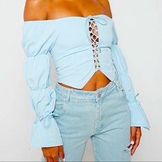 Blue Lace Up Triple Puff Sleeve Top Crop Top Silhouette Puff Sleeve Detailing Long Sleeves Self Tie Lace Up Front Detailing Self Tie Wrist Straps Fabric: 87% Cotton, 13% Elastane Blue Off-shoulder Top For Fall, Trendy Blue Puff Sleeve Blouse, Blue Trendy Crop Top For Spring, Trendy Light Blue Puff Sleeve Blouse, Trendy Blue Crop Top For Spring, Blue Off-shoulder Party Blouse, Blue Puff Sleeve Top For Spring, Spring Blue Puff Sleeve Tops, Chic Blue Crop Top For Fall