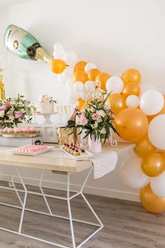 a party with balloons, cake and champagne