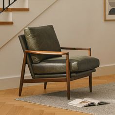 a chair sitting on top of a wooden floor next to a stair case