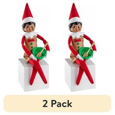 two christmas elfs sitting on top of each other