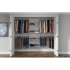 an open closet with clothes on hangers and pants hanging from the shelves in front of it