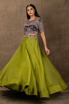 Pista green lehenga in organza. Comes with blue embroidered blouse.
Component: 2
Pattern: Embroidery
Type Of Work: Zardozi, Coin, Mirror and Sequin
Neckline: Round
Sleeve Type: Half
Fabric: Organza and Crepe
Color: Green,Blue
Other Details: 
Cutwork detail on the hems
Closure: Back zip
Note: Belt worn by the model is not for sale
Occasion: Sangeet - Aza Fashions Green Tissue Silk Choli With Intricate Embroidery, Green Organza Lehenga For Reception, Green Sharara With Intricate Embroidery In Tissue Silk, Green Organza Sharara With Intricate Embroidery, Green Organza Choli With Intricate Embroidery, Green Art Silk Gown With Intricate Embroidery, Bollywood Style Green Sharara For Formal Occasions, Green Bollywood Style Sharara For Formal Occasions, Green Silk Sets For Reception