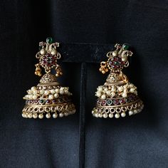 Brass alloy with stonework and pearly beading. Product Dimensions (inches): L: 2.3 B: 1.75 H: 1 Festive Jeweled Chandbali Pearl Earrings, Jeweled Pearl Earrings For Festivals, Jeweled Pearl Earrings For Festive Occasions, Traditional Silver Jeweled Jhumkas, Temple Jewelry Pearl Earrings With Stone Work, Festive Traditional Jeweled Pearl Earrings, Festive Metal Jeweled Earrings, Festive Jeweled Chandbali Jhumkas, Festival Chandbali Pearl Earrings With Jewels