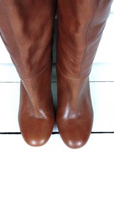 "90s brown tall cuffed high heel leather boots/rounded toe boots/9 Measurements... - marked size: USA 9 B -width at ball: 3\" -heel: 4\" -shaft height: 15.5\" -across top opening: 7\" Features... -genuine leather -cuffed top -round toe -Steve Madden Condition... -excellent leather condition -minor wear on soles 1G3011" Vintage Brown Knee-high Boots For Fall, Retro Brown Heeled Boots For Winter, Brown Wide Calf Platform Boots With Round Toe, Brown Knee-high Wedge Boots For Fall, Brown Wedge Boots With Stacked Heel And Round Toe, Brown Wide Calf Mid-calf Boots With Almond Toe, Brown Wide Calf Mid-calf Boots, Brown Mid-calf Wide Calf Boots, Retro Leather Knee-high Boots With Round Toe