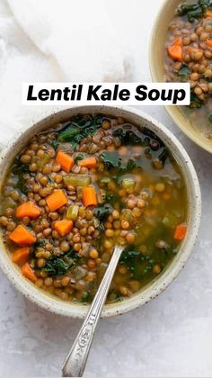 lentil kale soup with carrots and spinach in two bowls on a white surface