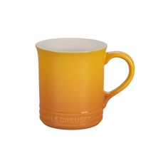 a yellow mug with the word le creuset on it