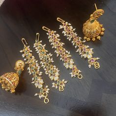 "Matilu is the traditional ear chain that finalizes the perfect look of the bride in South India. It draws attention to her head, which is held high beaming with pride and self-esteem. The same ear chain is referred to as \"Matti\" in Malayalam. This ornament is also worn by the dancers performing Kuchipudi or Bharatanatyam. It is attached to the earring, covering the ear and is fixed to the hair. This hair accessory also supports the heavy Jhimukka and imparts a complete look to the bride. Mati Ear Covering Earrings, Matilu Designs Gold, Matilu Designs, Jewerly Bracelets, Ear Chain, Chandbali Earrings, Gold Fashion Necklace, Gold Earrings Designs, Chain Design