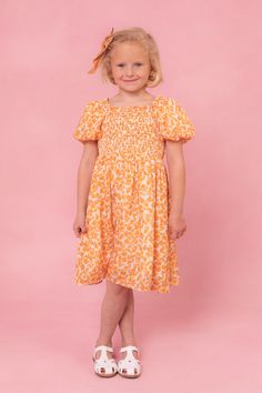 Get ready to turn heads in the Mini Serendipity Dress! This fun and playful dress features a vibrant yellow and white floral print on flowy chiffon fabric. The square neckline with ruffle detailing adds a touch of femininity, while the half-length puff sleeves with elastic band provide a comfortable and flattering fit. With a knee-length skirt and convenient pockets, this dress is as functional as it is stylish. The smocked bodice and stretch fabric at the shoulders, neckline, and bodice make fo Chiffon Dress Short, Thanksgiving Dress, Floral Print Chiffon, Holiday Party Dresses, Smocked Dress, Mom Dress, Everyday Dresses, Girls Rompers