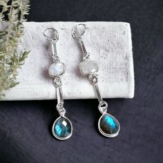 These dazzling long sterling silver earrings with etherial Labradorite and Moonstone semi-precious stones are perfect for a night out or when you want to amp up for outfit for the day! By Elizabeth Burry Design (Trinity, NL) Metal: 0.925 Sterling Silver Measures 2.75"L Turquoise Sterling Silver Earrings With Gemstone Accents, Silver Labradorite Gemstone Earrings, Silver Crystal Dangle Earrings With Natural Stones, Nickel-free Labradorite Jewelry, Sterling Silver Drop Earrings With Gemstone Accents, Fusion Earrings With Natural Stones In Sterling Silver, Sterling Silver Long Drop Fusion Earrings, Sterling Silver Drop Crystal Earrings With Gemstones, Elegant Nickel-free Labradorite Earrings