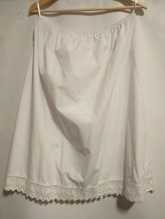 50% cotton , 50 % polyester With beautiful heart lace Chic White Skirt With Lace Patchwork, Lace Skirt With Lace Work, White Non-stretch Cotton Skirt, Non-stretch White Cotton Skirt, Fitted Summer Skirt With Delicate Lace, Summer Fitted Skirt With Delicate Lace, Elegant Summer Skirt With Lace Patchwork, Chic Lace Skirt For Daywear, Feminine Lace Skirt With Lace Trim