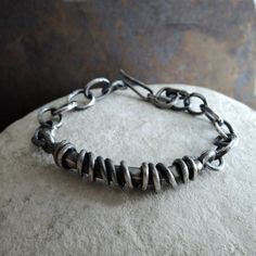 "Heavy raw silver bracelet for men. Silver 925 textured, oxidized. Main silver element: 6,7cm (2.64 in) x 1cm (0.4 in) Chain links: 1x 1,4cm (0.4\" x 0.55\") Weight at least 36g Choose your wrist circuit from the drop down menus. Please note, that the length of the bracelet is always 0.8 - 1.2 in bigger than its circuit (plus some links for adjustment). ----------------- Jewelry is packed in a jewelry box. -------------------------------" Metal Link Bracelets With Oxidized Finish, Oxidized Finish Sterling Silver Link Bracelet As Gift, Rustic Silver Bracelet Jewelry, Sterling Silver Oxidized Link Chain Bracelet, Oxidized Sterling Silver Link Bracelet, Sterling Silver Link Bracelet With Oxidized Finish, Bracelet For Men Silver, Unique Mens Bracelet, Silver Element