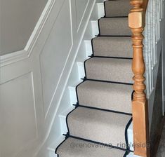 an image of a stair case with carpet on the bottom and handrails up