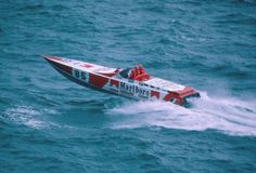 a red and white speed boat in the ocean