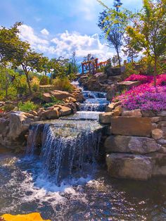 there is a waterfall in the middle of this garden