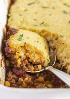 a casserole dish with meat and vegetables in it is being spooned into the casserole