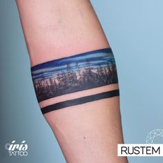 a tattoo on the arm of a person with trees in the background and blue sky