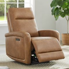 a brown recliner chair sitting on top of a rug