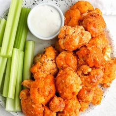 a plate with celery sticks and some fried food