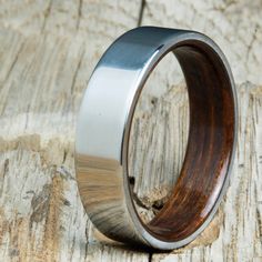 a wooden and stainless steel ring on wood