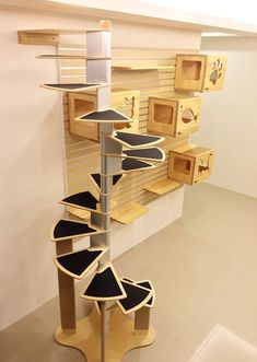 a spiral staircase made out of wooden crates in a room with white walls and flooring