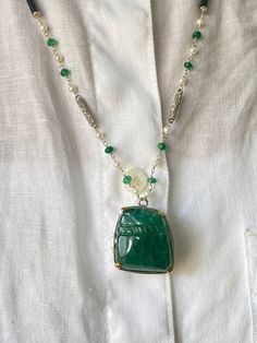 One-of-a-kind art-deco inspired pendant necklace with 54.04 carat Emerald. The center oval-shaped Emerald is supported by 18K White Gold. The chain is also styled in emerald, diamonds, and 18K White Gold. 18K White Gold : 6.62 Grams  Emerald : 54.04 Ctw Diamond : 0.35 Ctw Formal Green Emerald-cut Emerald Necklace, Luxury Hallmarked Pendant Emerald Necklace, Luxury Emerald-cut Emerald Necklaces, 14k Yellow Gold Emerald-cut Emerald Necklace, Luxury Bezel-set Emerald Pendant Necklace, Emerald Necklace Pendant, Purple Sapphire, Emerald Pendant, Pearl Earrings Dangle