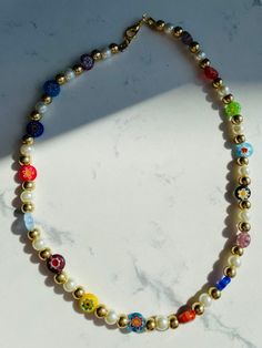 Millefiori Bead Necklace with Pearls, Handmade Rainbow multicolored Harry styles necklace choker, Gift for Her MATERIAL - Made of glass pearls and glass millefiori beads - Nickel and lead free NECKLACE LENGTH - 15.3 Inches ( 39 cm) If you want shorter (choker style 38-39 cm ), then please let me know. CLOSURE: Lobster claw CHAIN STYLE: Bead GIFT BOX - If you want a gift box, just let me know. PRODUCTION TIME -1-2 business days Necklace is handmade by me. CARE INSTRUCTIONS Avoid humidity, please Adjustable Multicolor Pearl Jewelry, Gold Necklaces With Letter Beads For Festivals, Festival Pearl Jewelry With Colorful Beads, Multicolor Pearl Jewelry With Letter Beads, Colorful Pearl Beaded Choker Necklace, Pearl Choker With Colorful Round Beads, Multicolor Adjustable Pearl Necklace With Tiny Beads, Multicolor Pearl Necklace With Letter Beads, Multicolor Pearl Beads For Gift