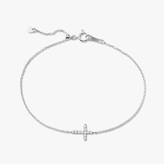 Our Esther Dainty Diamond Cross Bracelet is a glimmering beacon of faith. Stylish and elegant, this bracelet embodies the beauty of His grace. Perfect to shine on its own but sophisticated enough to add to a stack. The intentional delicacy of this design makes for the heartfelt gift of a child's first piece of fine jewelry or an adult's everyday dainty wear. Metal: 18k White Gold / 18k Yellow Gold / 18k Rose Gold Round Brilliant Cut Natural Diamonds: Approx. 0.10 ctw G Color and SI1-2 Clarity Diamonds Length: 7 inches at the longest. ﻿Adjustable sliding bead to provide options for smaller wrist size. Closure: Lobster clasp Measurements: Approx. 11.7mm length x 5.9mm width Looking for a different size? Please email us. Elegant Sterling Silver Cross Rosary Bracelet, Elegant Adjustable Cross Bracelet, Elegant Sterling Silver Round Rosary Bracelet, Elegant Sterling Silver White Gold Rosary Bracelet, Elegant Sterling Silver Rosary Bracelet, Collar Chain, Mens Engagement, Bridal Bands, Diamond Cross