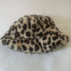 A Faux Fur Leopard Print Bucket Hat. New, Never Worn. Adjustable Brown Hats With Faux Fur Lining, Faux Fur Lined Brimmed Bucket Hat, Trendy Warm Brown Hats, Winter Brown Bucket Hat One Size, Trendy Brown Hat One Size, Trendy Brown Hats One Size, Trendy Brown One-size Hats, Brown Bucket Hat For Fall, One Size Fits Most, Trendy Brown Bucket Hat For Fall