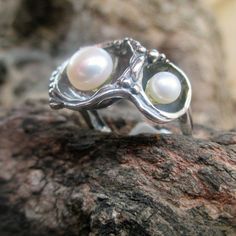 From Porans collection Hand Crafted Unique Sterling Silver Ring with 2 freshwater pearls(1x7 mm)(1x5mm ) this beauty like many of our jewelry, inspired by the amazing underwater life. Dimensions: Max Width:0.62 inches Height: 0.39 inches It can be made any size you need. Available with other stones! MATCHING EARRINGS: https://www.etsy.com/il-en/listing/120554888/sterling-silver-earrings-boho-jewelry?ref=shop_home_active_35&frs=1 MATCHING WATCH: https://www.etsy.com/il-en/listing/750089813/va Pearl White Pearl Ring For Anniversary, Unique Pearl Jewelry For Anniversary, Unique Pearl Ring Gift, Unique Pearl Promise Ring, Pearl White Sterling Silver Ring For Gift, Dainty Pearl Ring As A Gift, Silver Pearl Rings For Gift, Silver Ring With Pearl Charm, Oval Pearl Ring For Gift