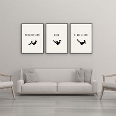 two black and white posters on the wall above a couch in a room with chairs