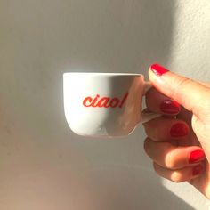 a woman's hand holding a coffee cup with the word cian on it