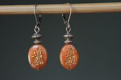 Made of oval dark orange and featuring a cat. Color : Dark Orange Semi-Translucent/Opaque Czech Glass - with Bronze Metallic inlay of Egyptian Cat Finish : Antique copper tone findings Size :  1,5 inches including the antique copper tone lever back. For more choices on my Czech glass Earrings, please refer to the link below : https://www.etsy.com/shop/NtikArtJewelry?ref=seller-platform-mcnav§ion_id=16062218 To visit my shop : https://www.etsy.com/shop/NtikArtJewelry FREE DOMESTIC SHIPPING ON ORDER OVER $35 AND UP ! All my jewelry are shipped in eco-friendly packaging making it a more sustainable choice for shipping. I usually ship between 1 and 3 business day with USPS first class. If you need an order sooner you can still select a priority mail at direct check out. I will do my best to se Handmade Oval Brown Earrings, Brown Oval Earrings As A Gift, Brown Oval Earrings Gift, Brown Oval Earrings For Gift, Egyptian Cat, Orange Earrings, Dark Orange, Earrings Drop, Cat Earrings