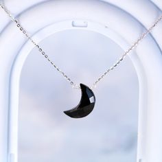 A subtly beautiful necklace for the minimalist who appreciates healing gemstones. This handmade pendant necklace features a carved black onyx crescent moon suspended from a delicate sterling silver chain - simple yet striking. Black onyx, a calming stone, lends an air of serenity when worn close to the heart. The sterling silver chain is cool and lightweight, ideal for everyday wear that doesn't demand attention yet flatters with understated elegance. An effortlessly chic accessory for the modern mystic. Materials: Black Onyx, 925 sterling silverChain length: 18 in adjustable any length shorter Jewelry Care: See more information about how to care for your jewelry here. Shipping Policy: Orders will be shipped within 1-3 business days. Economy shipping will take 7-14 days to arrive and stand Black Moon Phase Round Pendant Jewelry, Black Sterling Silver Moon Phase Necklace, Black Sterling Silver Moon Phase Jewelry, Black Moon Phase Necklace For Gift, Black Sterling Silver Jewelry With Moon Phase, Black Sterling Silver Jewelry With Moon Charm, Black Moon Shaped Sterling Silver Necklaces, Black Moon Sterling Silver Necklace, Black Moon-shaped Sterling Silver Necklace