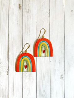 All I can say is... SO CUTE. These adorable acrylic rainbow earrings are going to make you so happy. The rainbows feature shades of orange, blue, yellow, green, and little red hearts. They're lightweight and nickel free, so they'll make your ears happy as well! Cute Rainbow Dangle Earrings, Retro Rainbow Earrings For Gift, Fun Rainbow Colored Earrings As Gift, Fun Rainbow Drop Earrings, Playful Rainbow Earrings With Ear Wire, Fun Rainbow Earrings, Orange Rainbow, Rainbow Arch, Arch Earrings