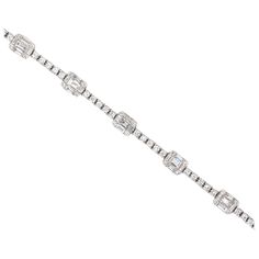 18K White gold tennis bracelet featuring 55 baguette diamonds weighing 1.59 carats flanked with 99 round brilliants weighing 1.12 carats. Color G-H Clarity SI Diamond Tennis Bracelet With 17 Jewels And Baguette Cut, Diamond Baguette Cut Tennis Bracelet, Baguette Cut Single Diamond Tennis Bracelet, Bracelets Tennis, Gold Tennis Bracelet, Diamond Baguette, Bracelet Tennis, Vintage Tennis, Baguette Diamonds