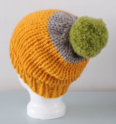 "Yellow Super Chunky Beanie Hat, knitted using 100% merino wool in yellow and grey and finished with a large green pom pom.  Features a ribbed brim and has a bit of slouch.   >Materials - 100% Merino Wool >Measurements - Ideal for a 21.5-23\" head, fitted around the brim with a slouch at the back.  >Care Instructions - Gently hand wash in cool water >More Hats - http://etsy.me/1skjQTY" Yellow Knitted Hat, One Size Fits Most, Yellow Yarn Crochet Beanie Hat, Yellow Knitted Hat One Size Fits Most, Yellow One-size Yarn Beanie, Hand Knitted Yellow Crochet Hat, Yellow Yarn Crochet Hat, Yellow Knitted One-size-fits-most Hat, Yellow Knit Beanie Hat, Yellow Hand Knitted Beanie Crochet Hat