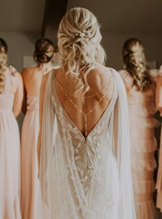 the back of a bride's dress in front of other bridesmaids