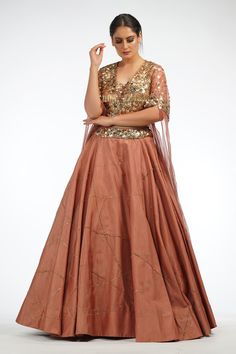 Cinammon cap sleeve flared blouse with sequin embroidered motifs. Paired with flared lehenga.
Components:2
Pattern:Embroidered
Type of Work:Sequin
Neckline:Square
Sleeve Length:Cap sleeves
Fabric:Silk, chiffon
Color:Brown
Other Details:
Flared sleeves
Embroidered waistband

Occasion:Sangeet - Aza Fashions Designer Lehenga With Sequins And Cape Sleeves, Festive Sequined Choli With Cape Sleeves, Festive Sequined Cape Sleeve Choli, Traditional Choli With Cape Sleeves And Sequins, Traditional Choli With Sequins And Cape Sleeves, Traditional Lehenga With Sequins And Cape Sleeves, Diwali Sequin Lehenga With Cape Sleeves, Festive Lehenga With Sequins And Cape Sleeves, Diwali Lehenga With Sequins And Cape Sleeves