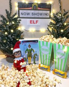 an elf is sitting in front of some popcorn