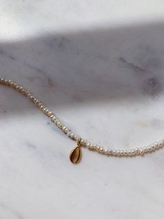 This gorgeous dainty natural pearls anklet comes with gold plated sterling silver shell pendant charm. Wear it on it's own or layer with other anklets in our collection. Pearls are symbolic of wisdom gained through experience. The gems are believed to offer protection, as well as attract good luck and wealth. Pearls are symbolic of the wearer's loyalty, generosity, integrity, and purity The surface of the pearls may have few bumps and ridges that indicate the natural origin of the pearls. The an Anklet Gold, Anklet For Women, Gold Beach, Beach Bracelet, Pearl Anklet, Ankle Bracelet, Shell Pendant, Ankle Bracelets, Natural Pearls